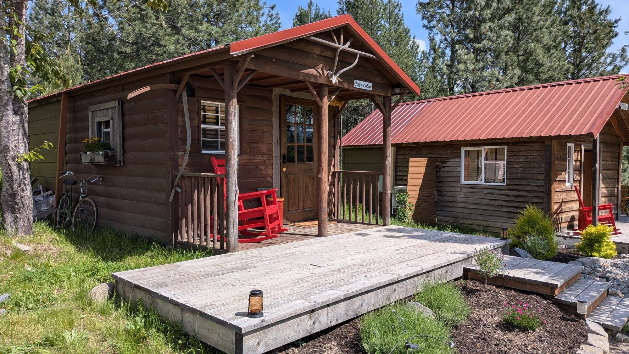 Izzy's Log Cabin exterior with a red rocker on the covered porch