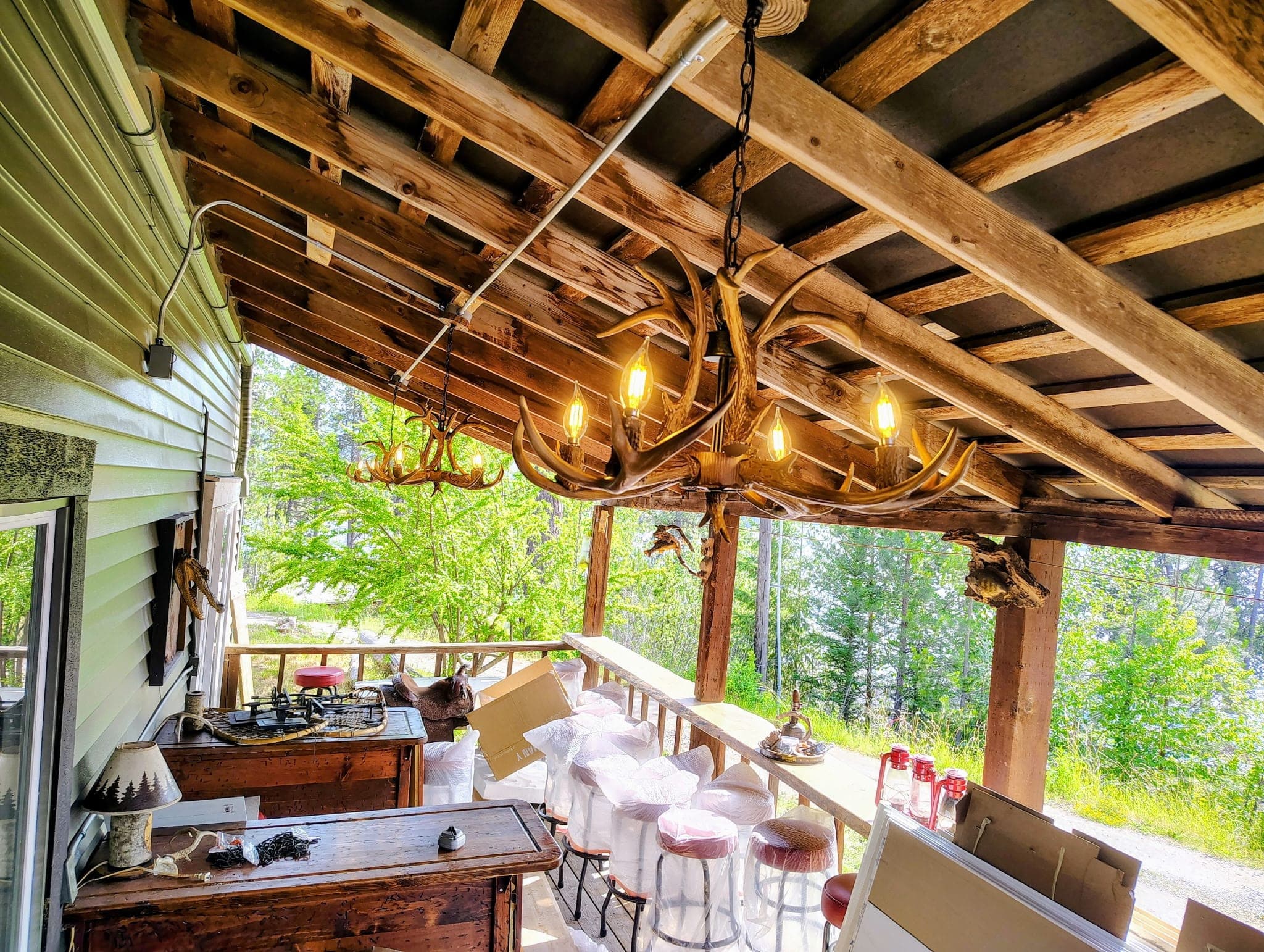Antler chandelier glowing over the prep on the deck at Red’s Tavern, Watson’s Lakefront Resort