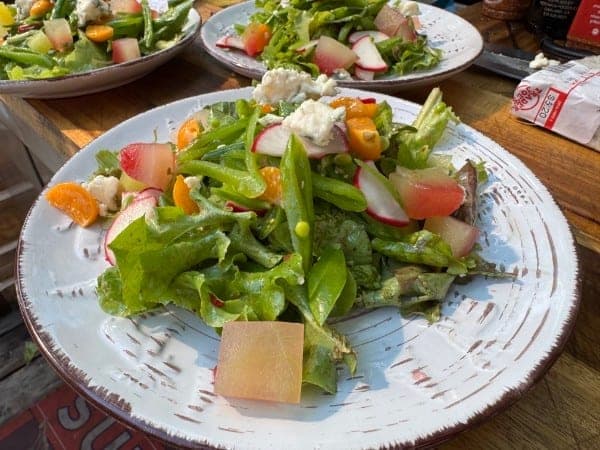 Stone-fruit salad with peaches, plums, blackberries, and microgreens at Red's Tavern