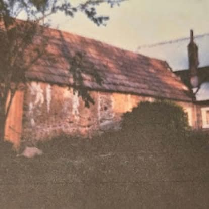 Vintage photograph of an ivy and vine-covered outbuilding on the historic Watson's property