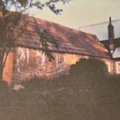 Historic vine-covered building on the Watson's Lakefront Resort property — a piece of the same Cataldo era as Old Mission